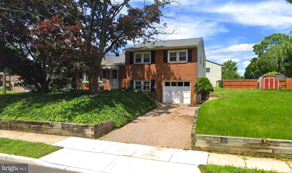 view of front facade with a garage, a front lawn, and a storage unit