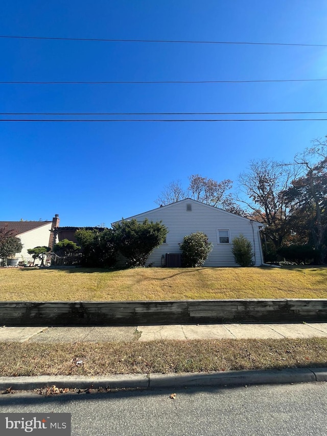 view of side of home with a lawn