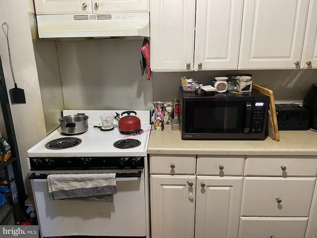 kitchen with white cabinets and white electric range