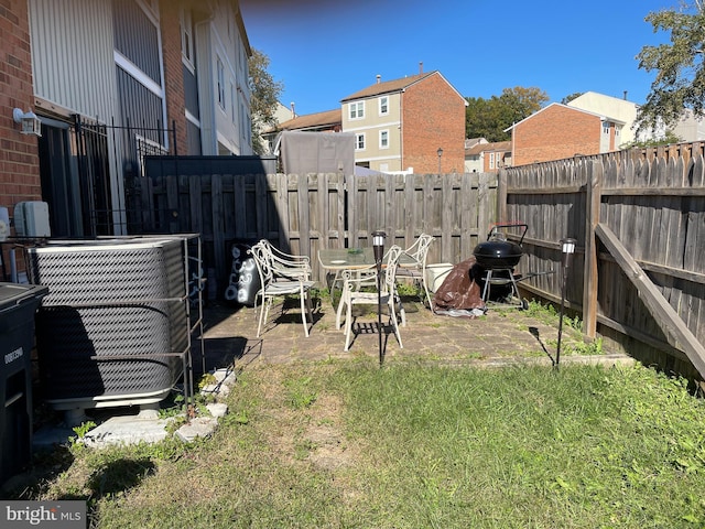 view of yard with a patio area and central AC unit