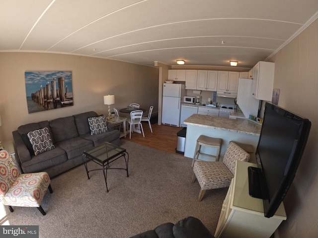 living room with ornamental molding, sink, and wood-type flooring