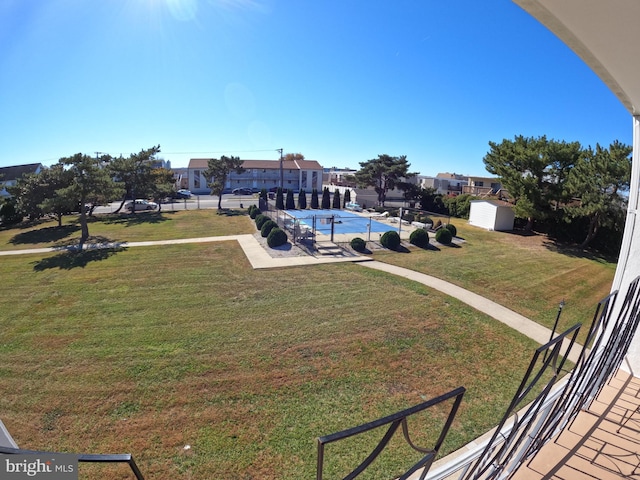 exterior space featuring a community pool and a storage unit