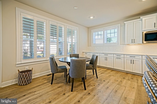 dining area with baseboards, recessed lighting, and light wood-style floors
