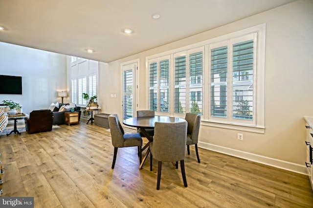 dining space featuring recessed lighting, wood finished floors, and baseboards