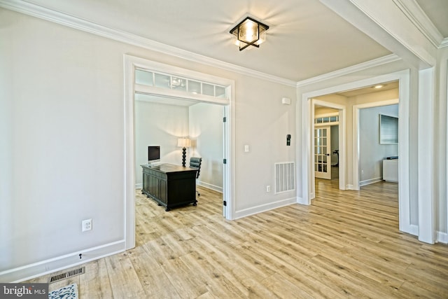 interior space with visible vents, crown molding, and light wood-style floors