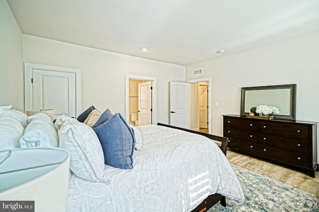 bedroom featuring visible vents and light wood-style floors