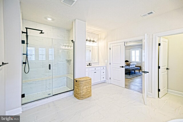 bathroom featuring visible vents, a shower stall, vanity, and marble finish floor