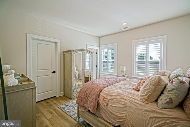 bedroom with visible vents and light wood-type flooring