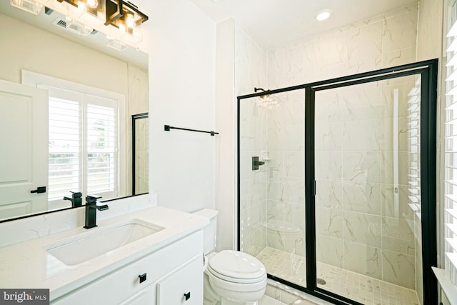 bathroom with visible vents, a stall shower, toilet, and vanity