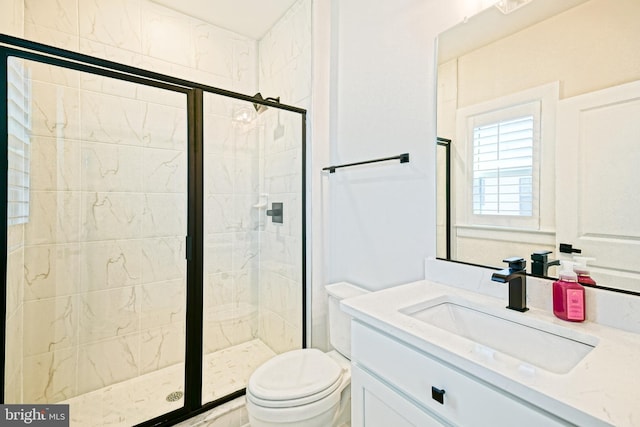 bathroom featuring vanity, toilet, and an enclosed shower