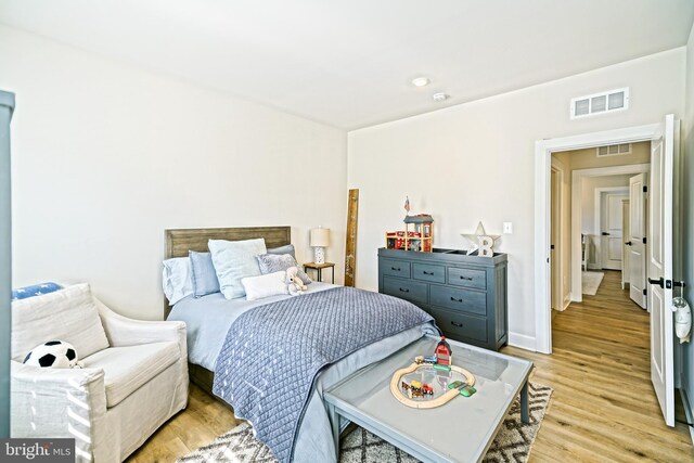 bedroom with visible vents and light wood-style floors