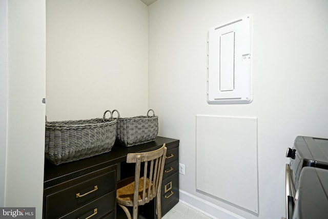 home office featuring independent washer and dryer, electric panel, and light tile patterned floors