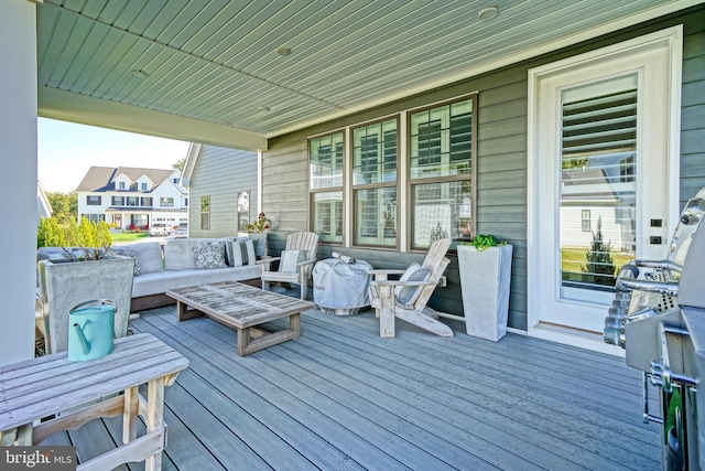 wooden terrace with an outdoor hangout area