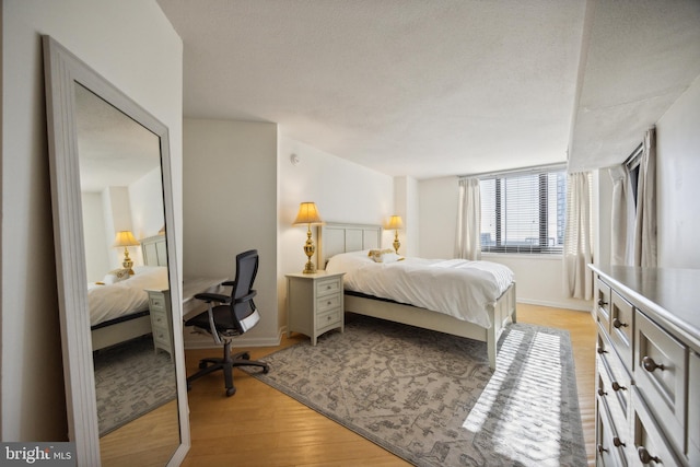 bedroom featuring a textured ceiling and light wood-type flooring