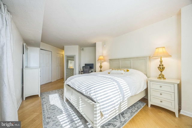 bedroom featuring light hardwood / wood-style flooring and a closet