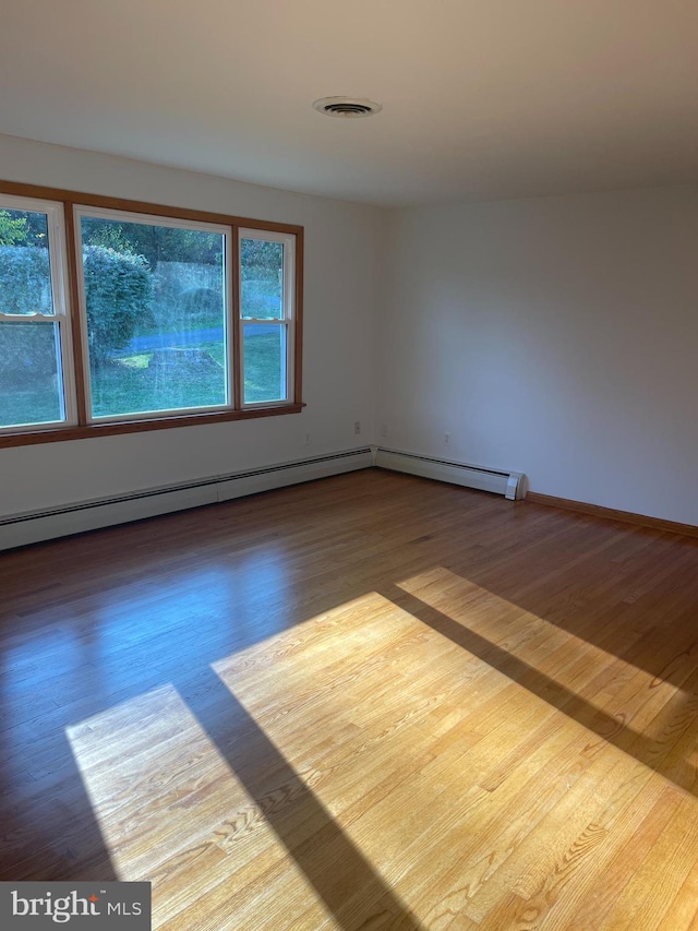 unfurnished room with hardwood / wood-style floors and a wealth of natural light