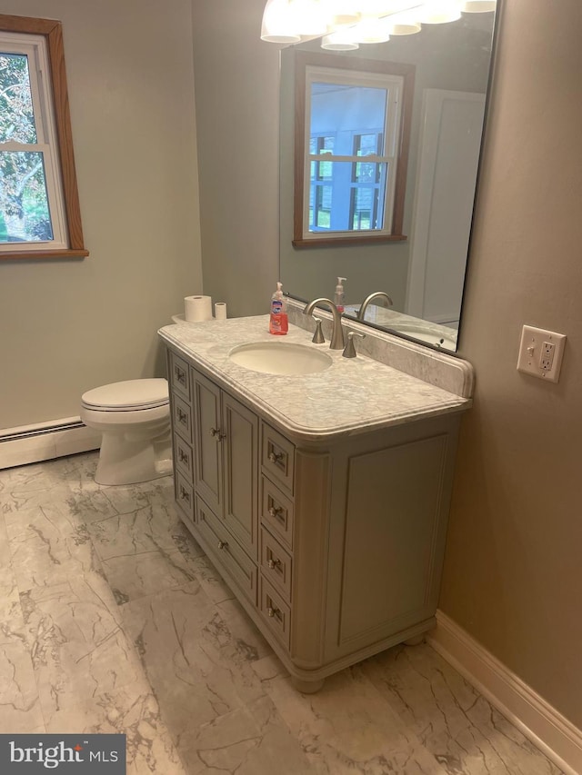 bathroom with vanity, toilet, and a baseboard radiator