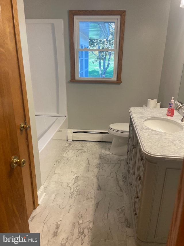 bathroom featuring baseboard heating, vanity, toilet, and a bathing tub