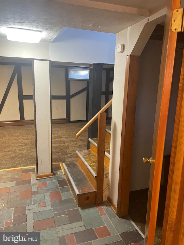 basement featuring dark colored carpet