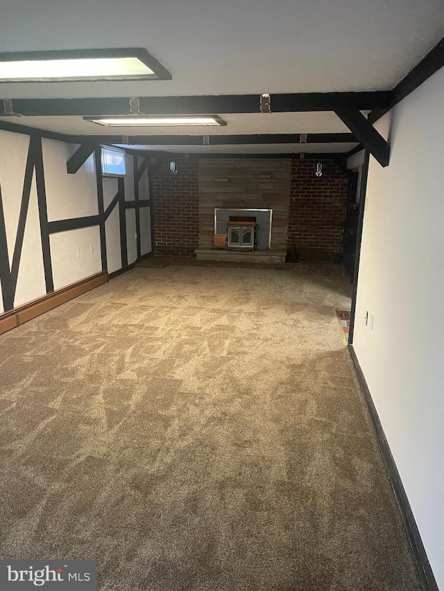 basement featuring carpet and a wood stove