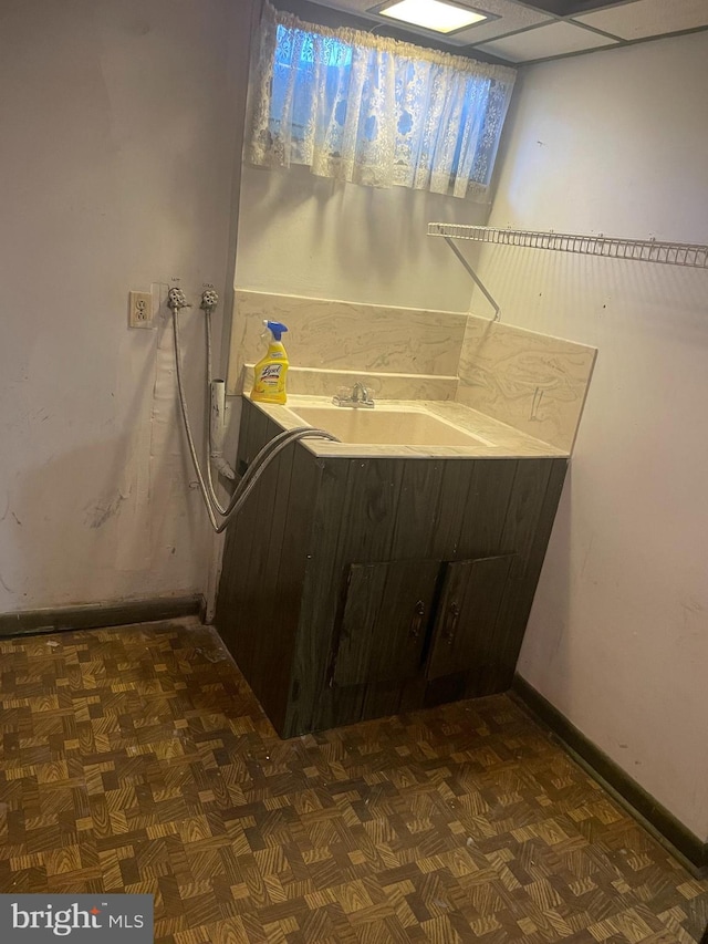 bathroom featuring parquet flooring and a paneled ceiling