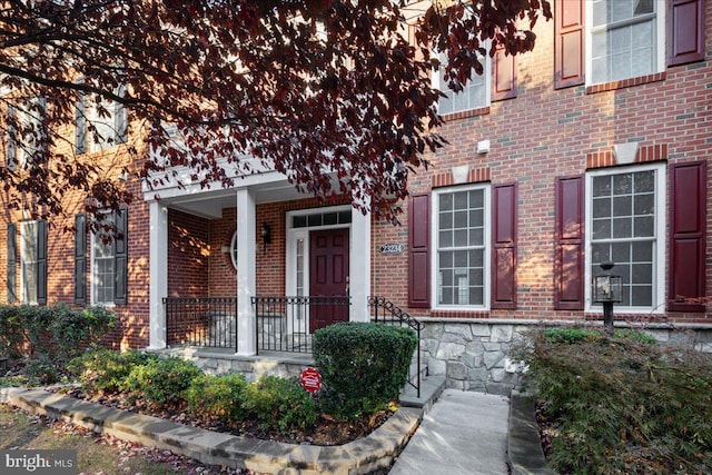 view of exterior entry with covered porch