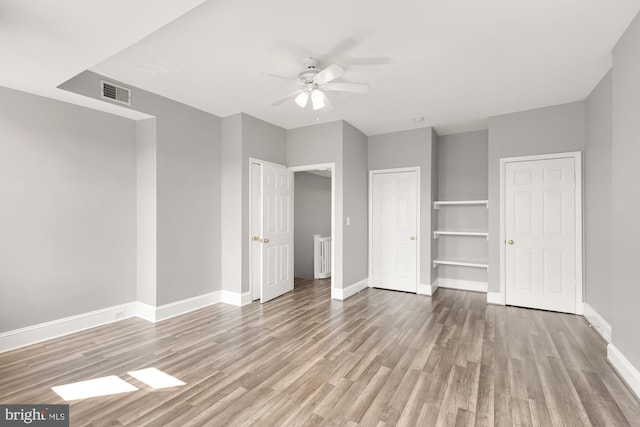 unfurnished bedroom featuring light wood-type flooring and ceiling fan