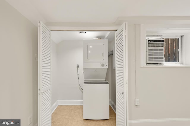 washroom featuring light tile patterned flooring, a wall unit AC, and stacked washer and clothes dryer