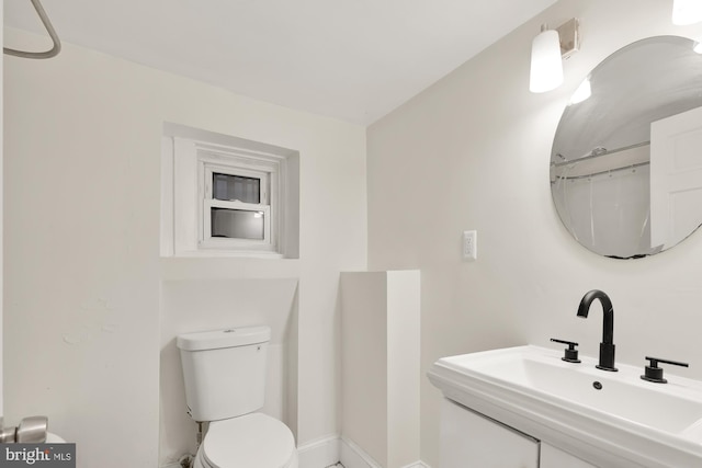 bathroom featuring toilet and vanity