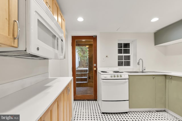 kitchen featuring white appliances, light brown cabinetry, sink, and green cabinetry