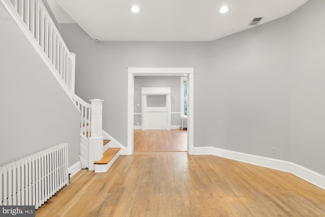 interior space with light hardwood / wood-style floors and radiator heating unit