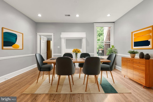 dining space with light hardwood / wood-style flooring