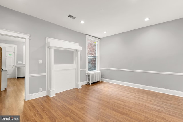 interior space featuring light hardwood / wood-style floors and radiator heating unit