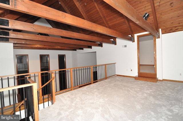 carpeted spare room with lofted ceiling with beams and wood ceiling