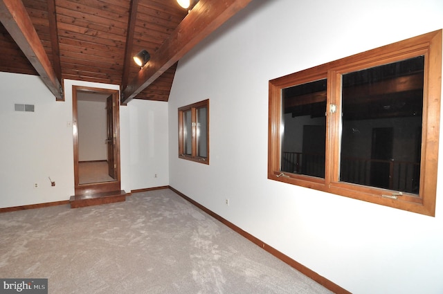 carpeted spare room featuring lofted ceiling with beams and wooden ceiling