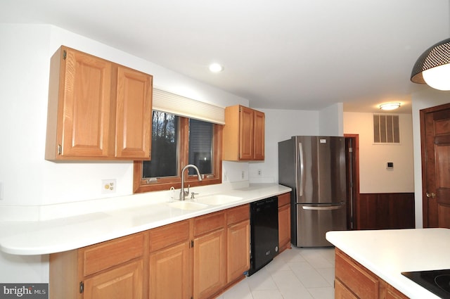 kitchen featuring light tile patterned floors, sink, and black appliances