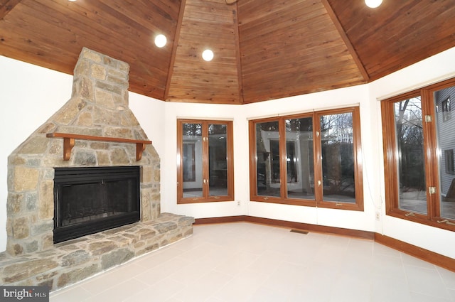 unfurnished living room with a stone fireplace, high vaulted ceiling, and wooden ceiling