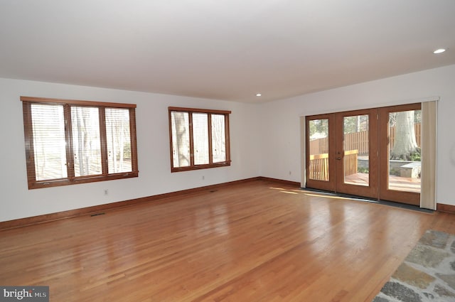 spare room featuring light hardwood / wood-style floors and french doors