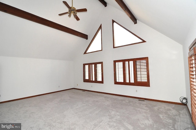 bonus room with beamed ceiling, ceiling fan, and light carpet