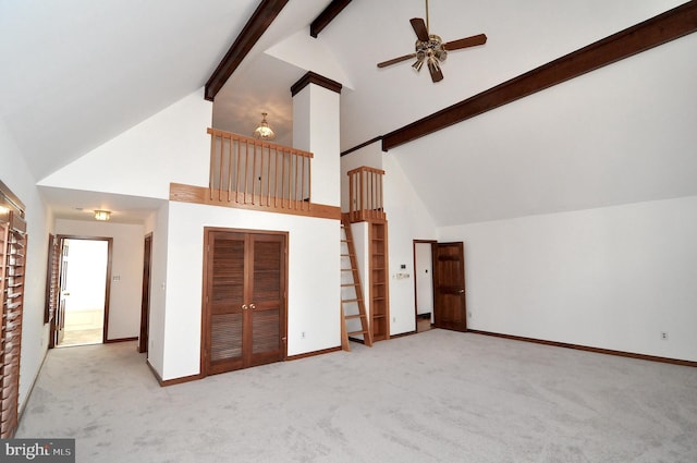 interior space featuring light carpet, ceiling fan, high vaulted ceiling, and beamed ceiling