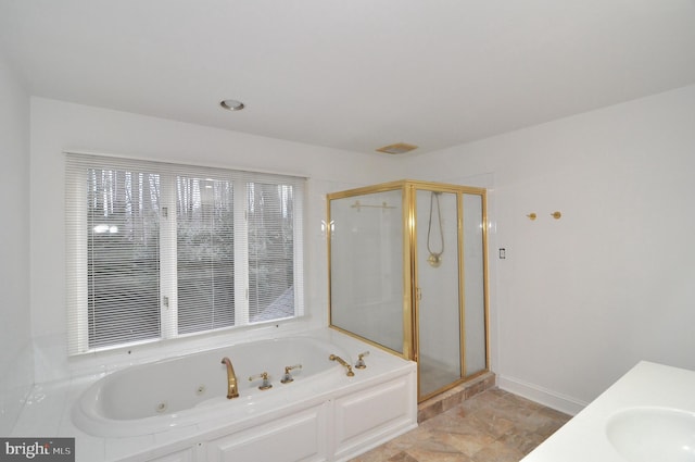 bathroom featuring sink and plus walk in shower