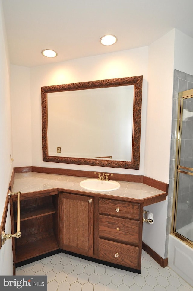 bathroom featuring enclosed tub / shower combo and vanity