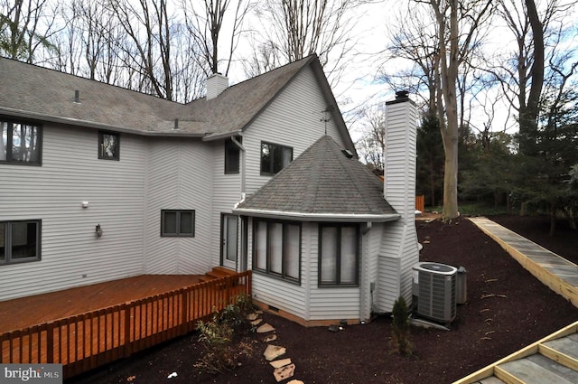 back of house with cooling unit and a wooden deck