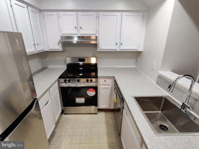 kitchen with stainless steel appliances, sink, exhaust hood, and white cabinets