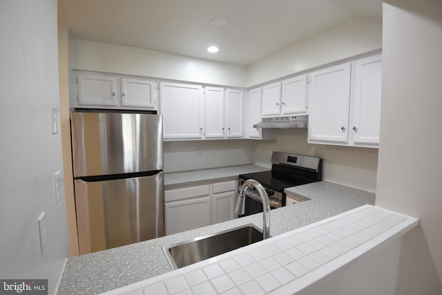 kitchen with tile countertops, sink, white cabinetry, and stainless steel appliances