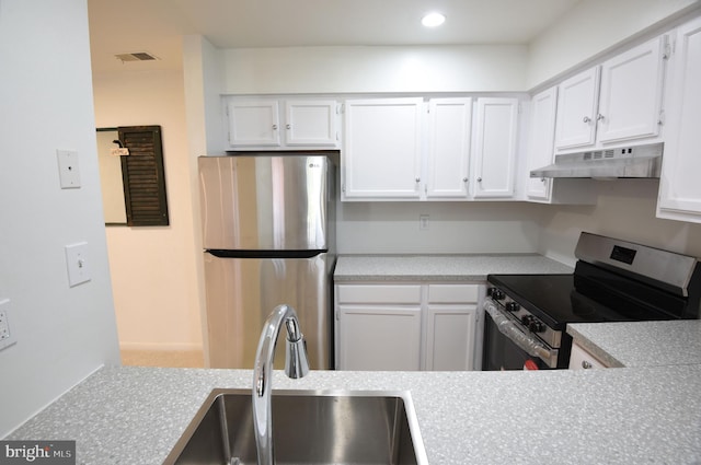 kitchen featuring stainless steel appliances, sink, and white cabinets