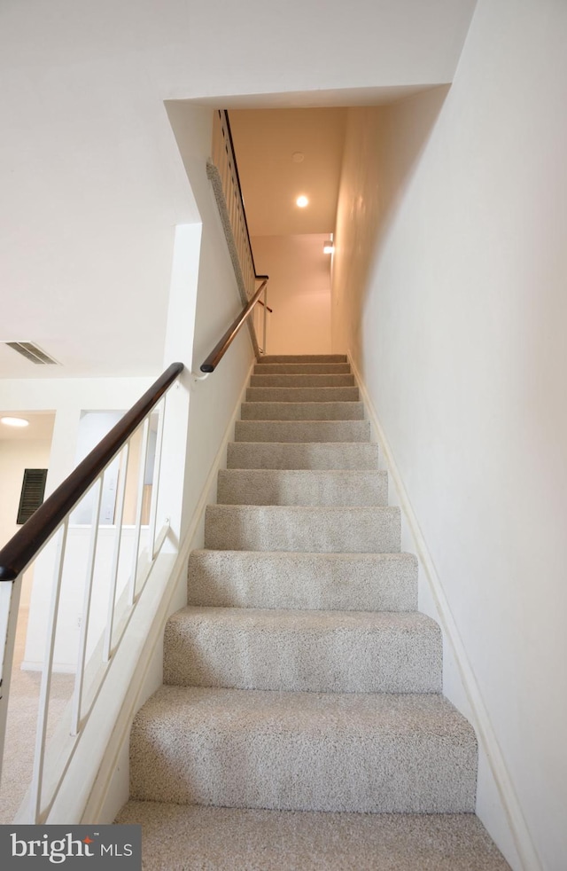 stairway with carpet floors