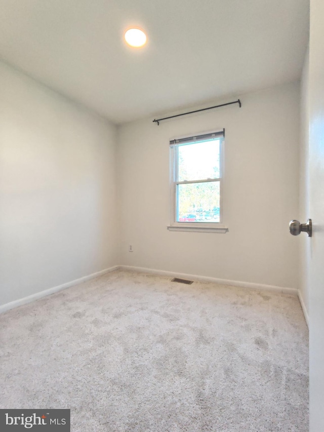 empty room with light colored carpet