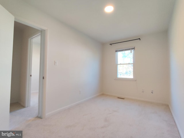 spare room with light colored carpet