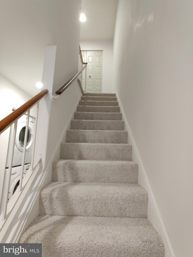 stairs with stacked washer and dryer